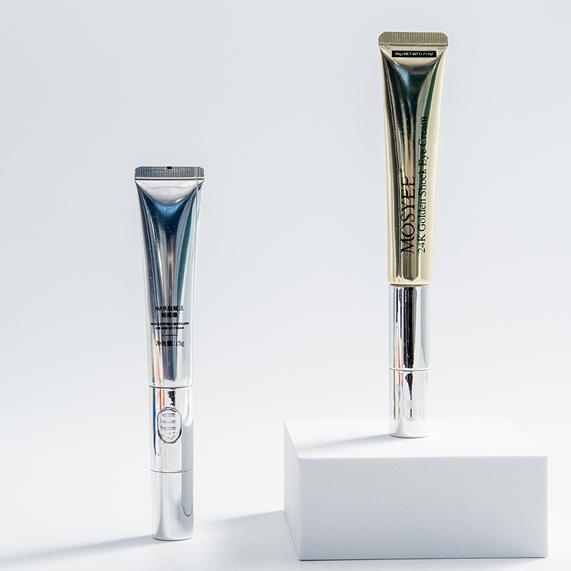 Eye cream tube packaging examples in silver and gold tones