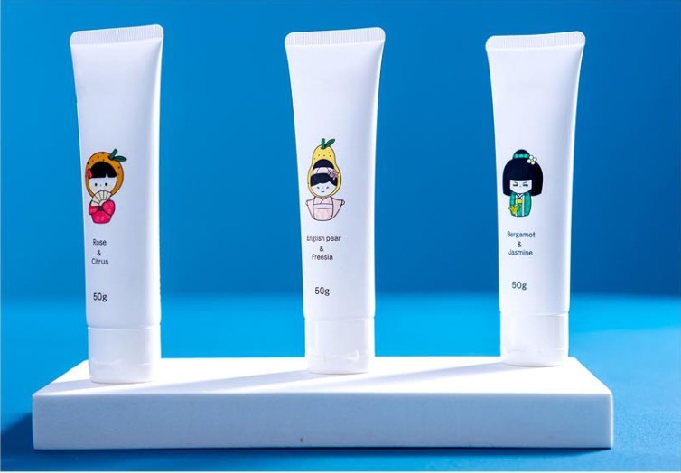 Three printed hand cream tube samples with white caps